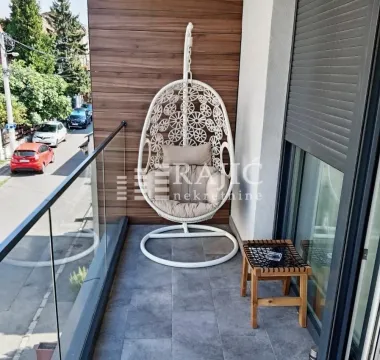 Modern furnished balcony with a hanging chair. - image 15