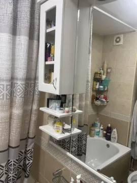 Small bathroom with a bathtub, mirrored cabinet, and shower curtain. - image 12