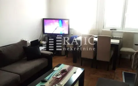 Living room with sofa and dining area. - image 3