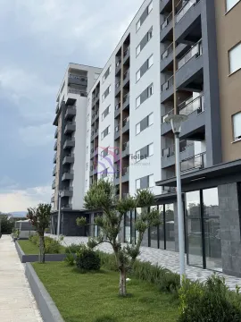 Exterior view of a modern residential building with a landscaped yard. - image 2
