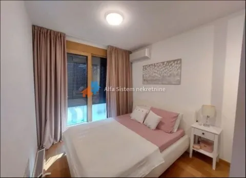 Bedroom with a double bed, bedside table, and access to the terrace. - image 14
