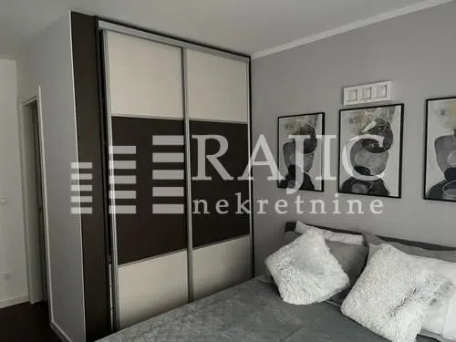 Modern bedroom with a double bed and a large wardrobe.
