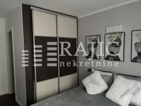 Modern bedroom with a double bed and a large wardrobe. - image 13