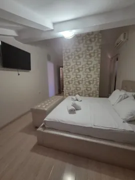 Bright bedroom with a double bed and a TV. - image 11
