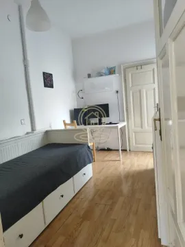 Smaller bedroom with a pull-out bed and a desk. - image 6