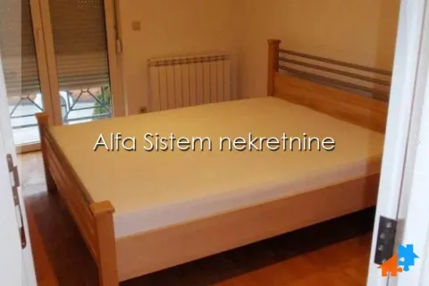Bedroom with a wooden bed and access to the terrace. - image 16