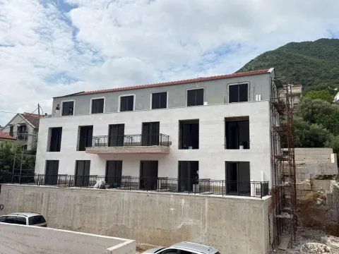 View of the exterior of a building under construction with a stone facade. - image 4
