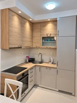 Kitchen with wooden cabinetry, sink and built-in oven. - image 2