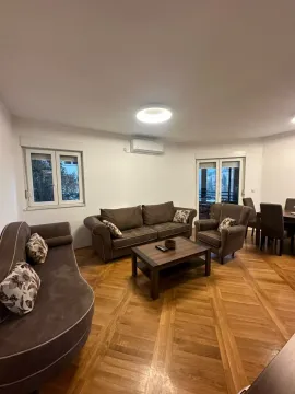 Living room with a sofa set, coffee table, and wooden parquet flooring. - image 12