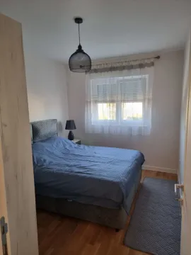 Small bedroom with a double bed and a window. - image 4