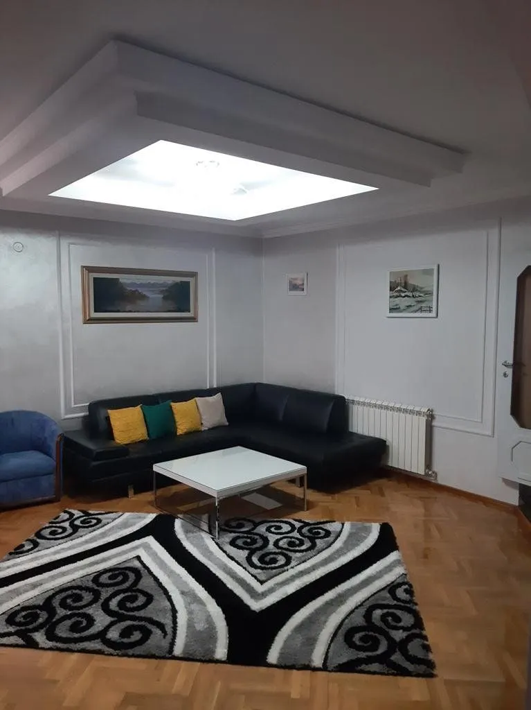 Living room with a sectional sofa, coffee table, and rug.