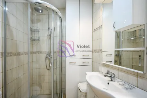 Bathroom with a shower cabin, washbasin, and built-in cabinet. - image 13