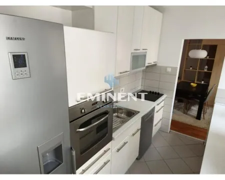 Kitchen with white cabinetry, refrigerator and built-in appliances. - image 7