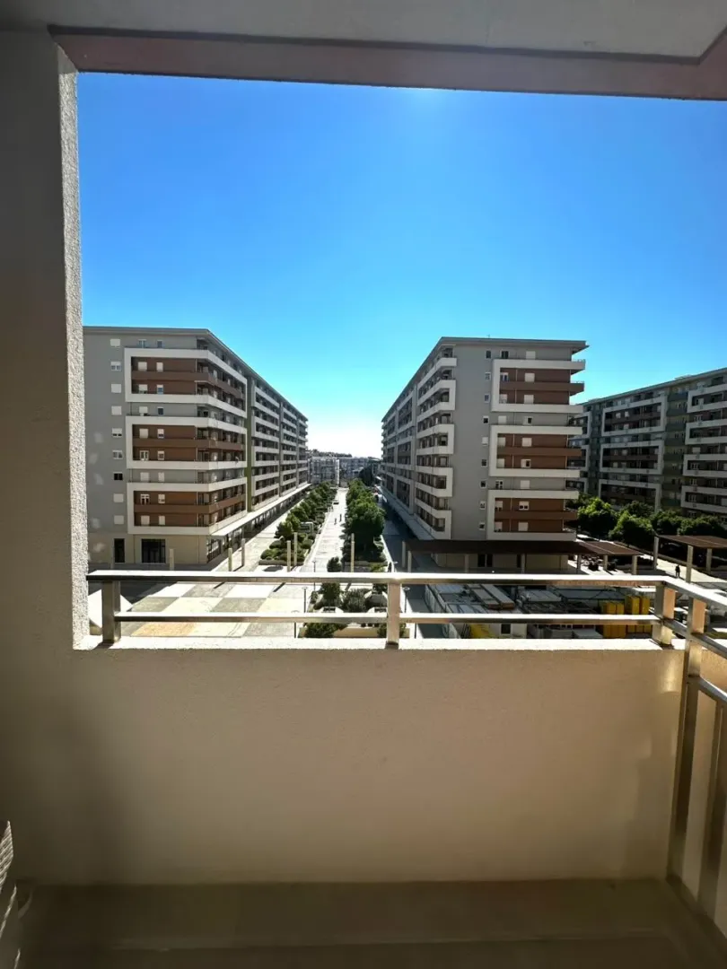 View from the balcony overlooking residential buildings and the neighborhood.