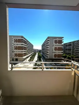 View from the balcony overlooking residential buildings and the neighborhood. - image 2