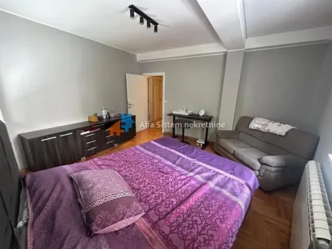 Bedroom with a double bed, sofa and chest of drawers. - image 11