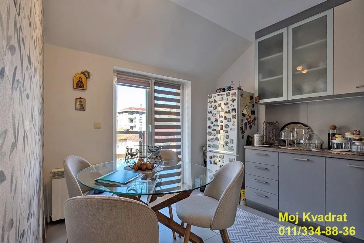 Kitchen with a dining table and chairs near the window.