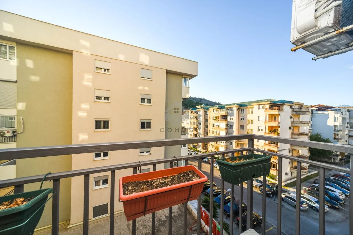 View from the balcony overlooking surrounding buildings and the street.