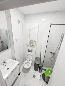 Modern bathroom with a walk-in shower, washbasin, and wall-mounted toilet. - image 3