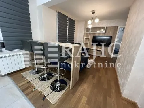 Living room with a bar counter and dining table.