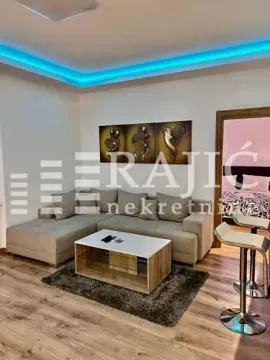 Living room with a sectional sofa, coffee table, and decorative lighting. - image 3