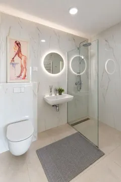 Savremeno opremljeno kupatilo sa tuš kabinom, umivaonikom i ugradnom wc šoljom. - image 10