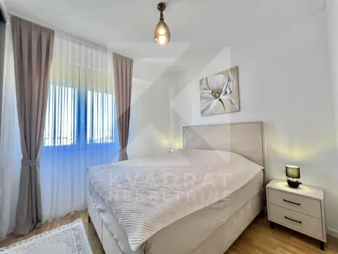 Furnished bedroom with a double bed, nightstand, and window with curtains. - image 5