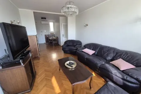 Living room with a sofa set, TV, and parquet flooring. - image 12