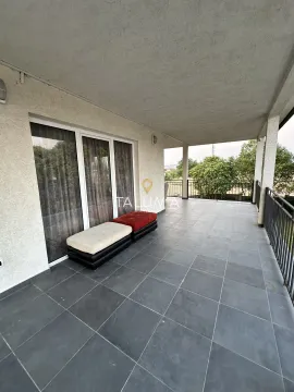 Spacious covered terrace with ceramic tiles and railing. - image 10
