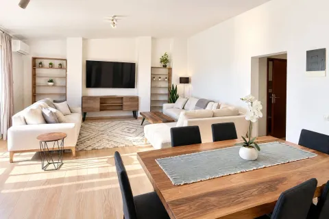 Spacious and bright living room with a dining area and modern furniture. - image 2