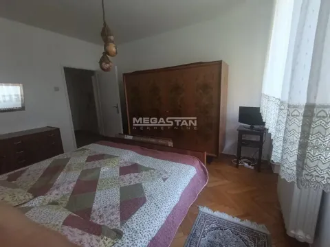 Bedroom with a double bed, wooden wardrobe, and parquet flooring. - image 5