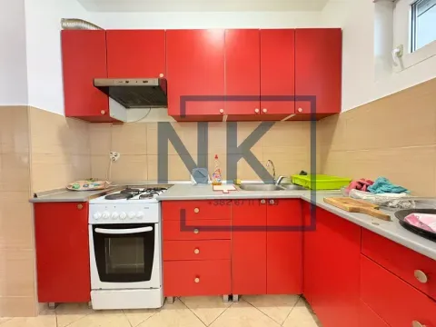 Kitchen with red cabinets and a white stove. - image 3