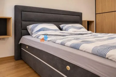 View of a double bed with a padded headboard in the bedroom. - image 6