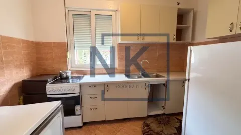 Small kitchen with white cabinets, stove, and refrigerator. - image 10