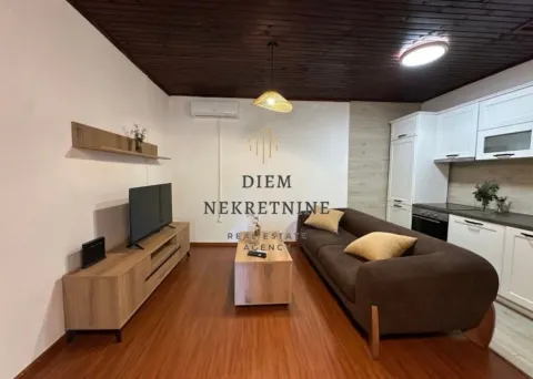 Living room with sofa and dining area in an open space layout. - image 2