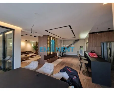 Spacious open-plan living room with dining area and kitchen. - image 11