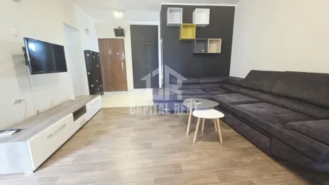 Living room with a corner sofa, television, and coffee table. - image 18