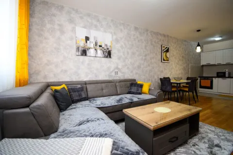 Living room with sofa, coffee table and a view of the kitchen in the background. - image 3