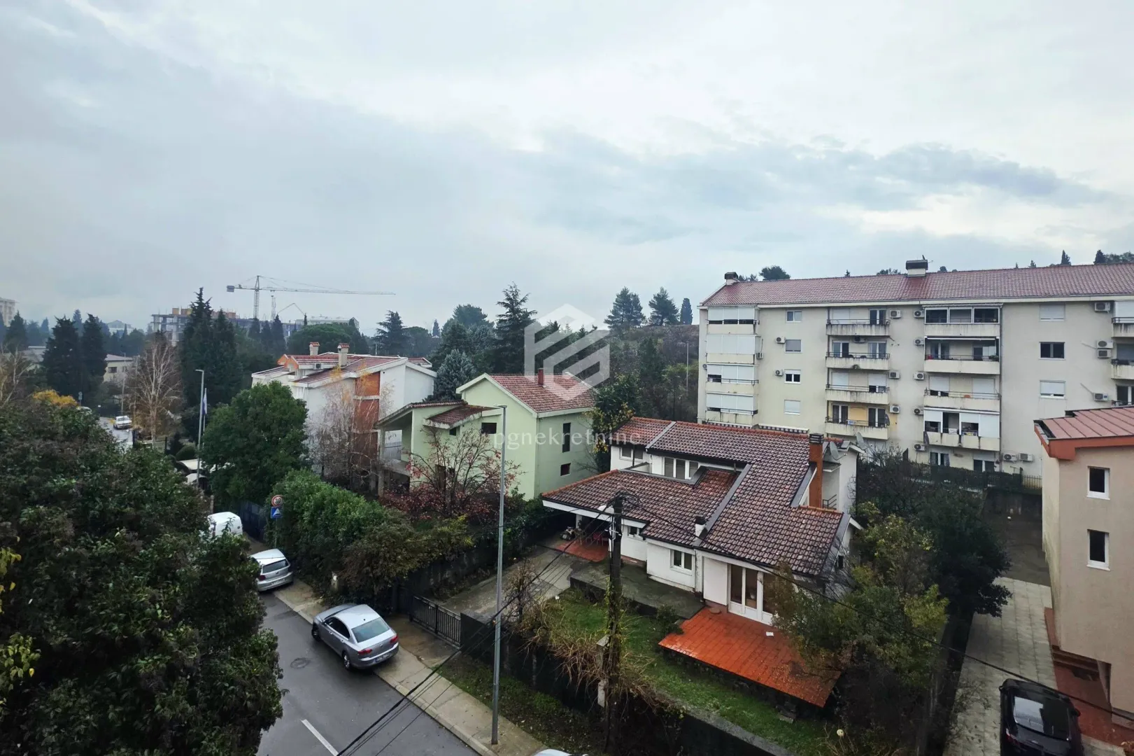 View from the window overlooking surrounding buildings and greenery.