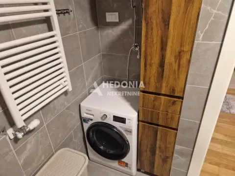 Bathroom with a washing machine, radiator and wooden cabinet. - image 13