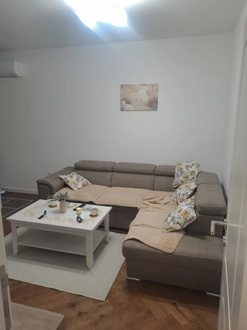 Living room with a corner sofa and a coffee table.