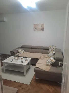 Living room with a corner sofa and a coffee table. - image 2