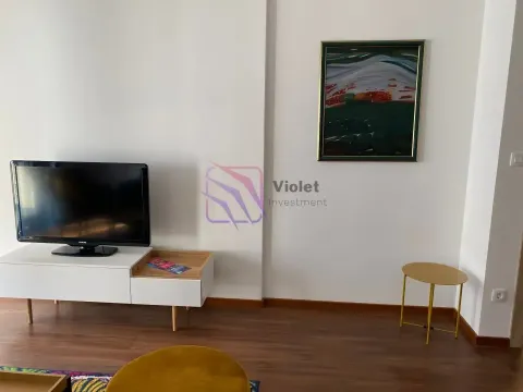 Living room with a television on a cabinet and a painting on the wall. - image 3