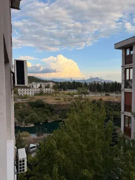View from the terrace overlooking the river and surrounding greenery. - image 12