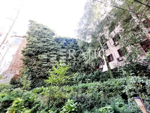 Exterior view of the building with lush greenery and ivy-covered facade. - image 2