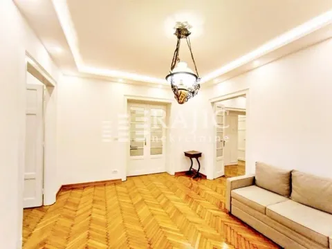 Spacious living room with parquet flooring and a sofa. - image 7