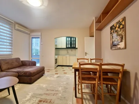 Living room with sofa, dining area, and a view of the kitchen. - image 7