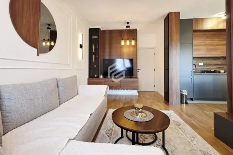 Living room connected to the kitchen, furnished with wooden details. - image 3