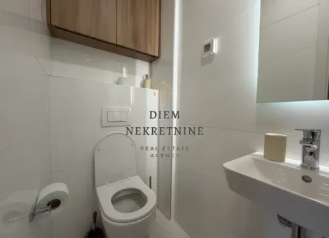 Modernly equipped bathroom with white tiles and a wall-mounted cabinet. - image 14
