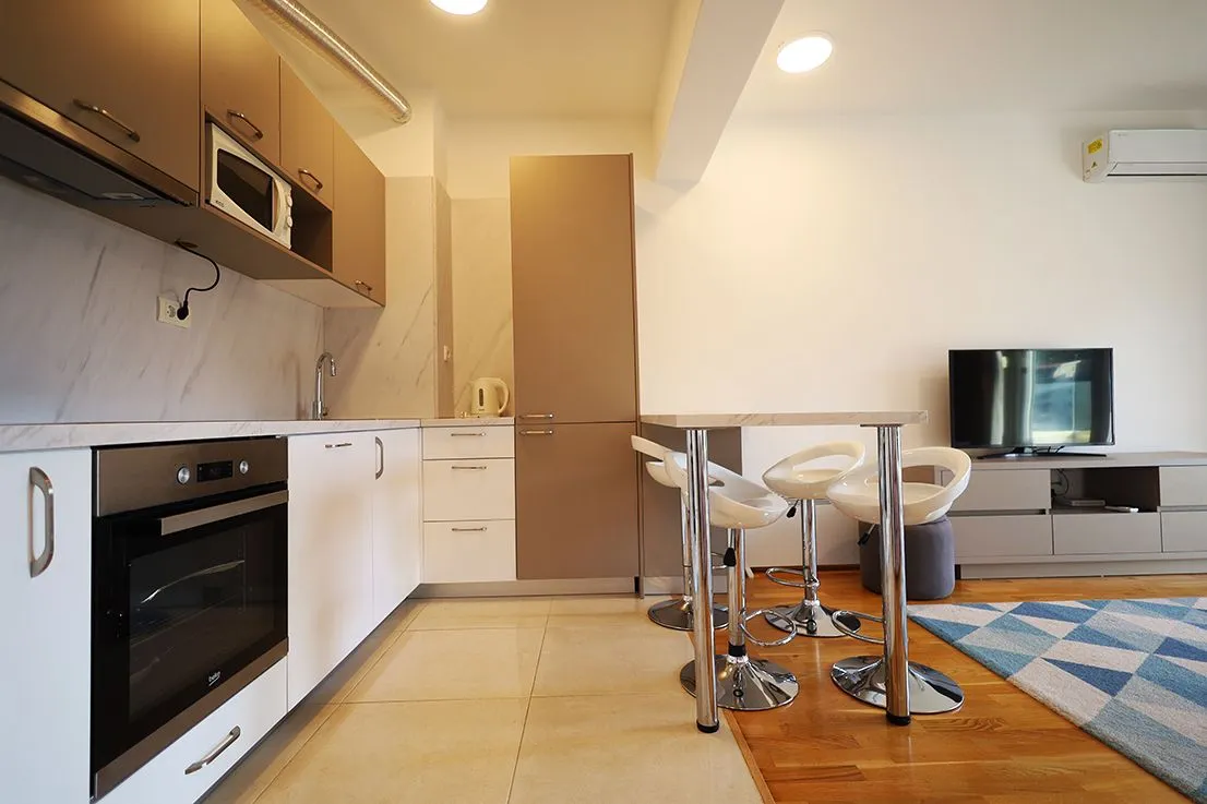 Modern kitchen connected to the dining and living area.
